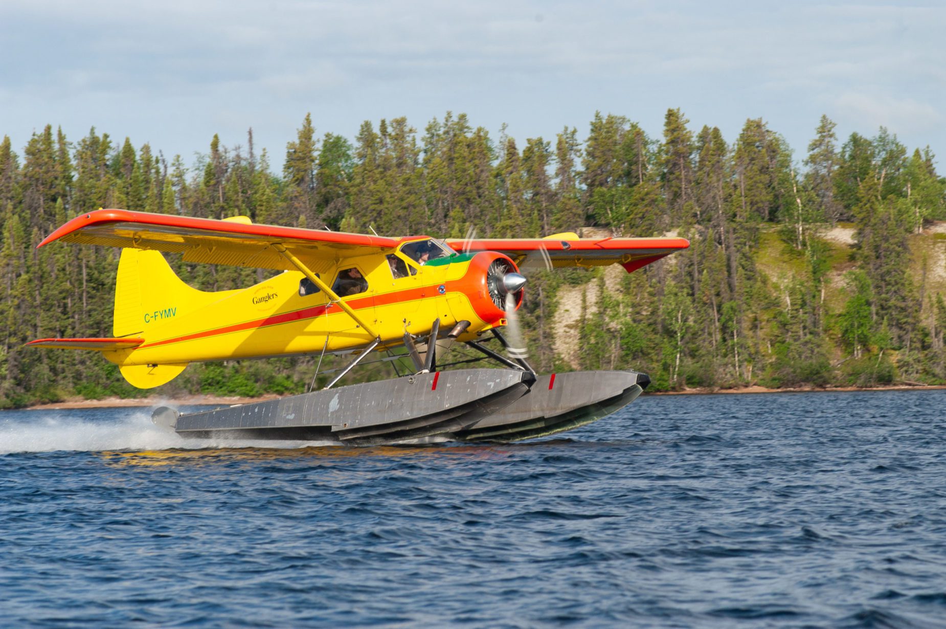 Gangler's yellow floatplane taking off from water