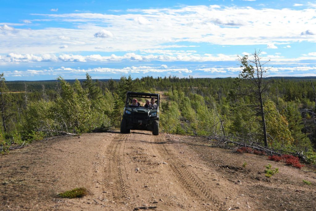 Truck driving down dirt road in nature landscape